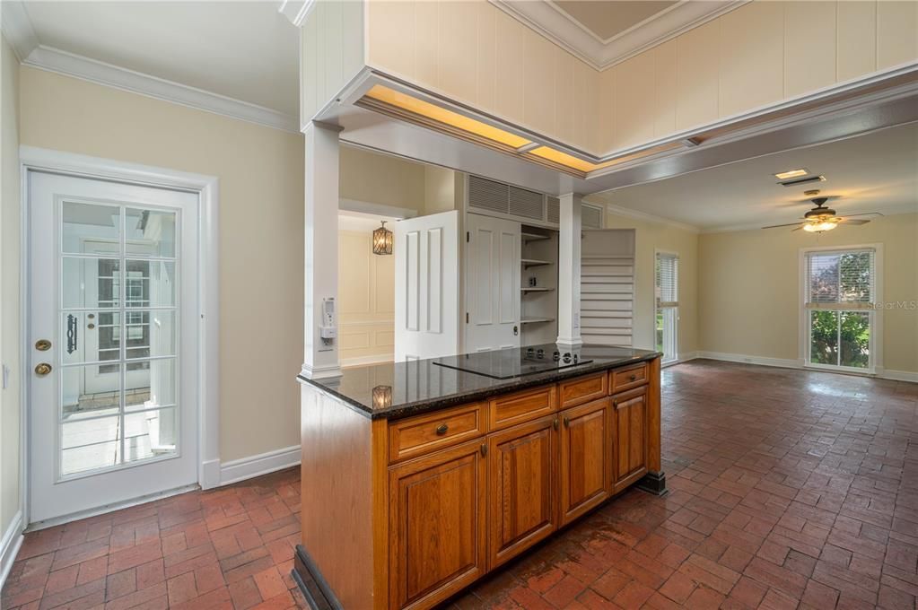 Kitchen has large double doored Pantry, a door going on to the Patio and into Garage, a door to the Screened Porch. Note floor to ceiling windows for lots of light”