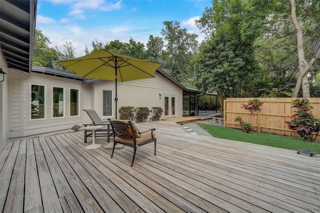 Deck leading from covered porch to pool