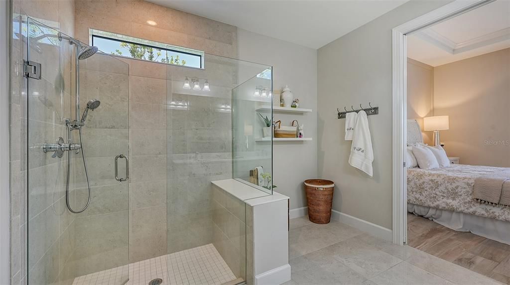 Walk-in shower with a transom window for extra lighting and plenty of room for a bench