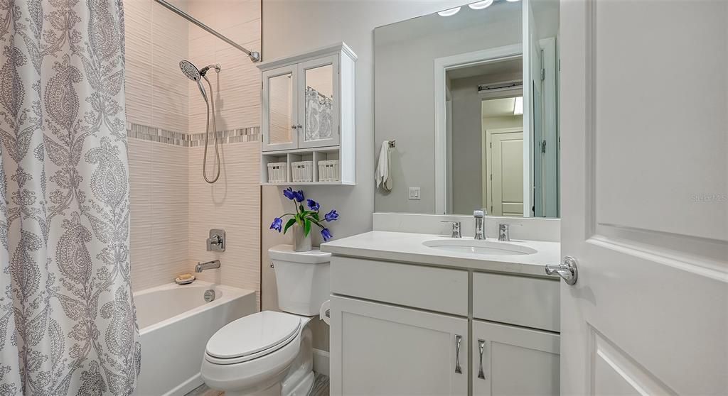 This bathroom has a bathtub and an additional closet inside for extra supplies