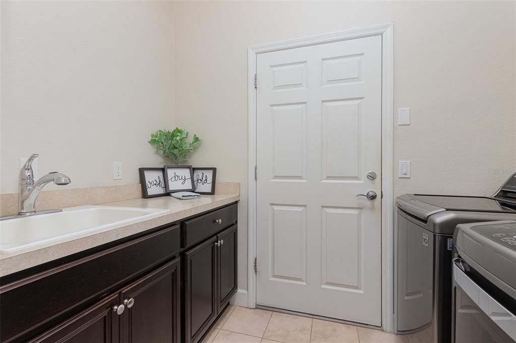 Spacious laundry room with sink and folding area