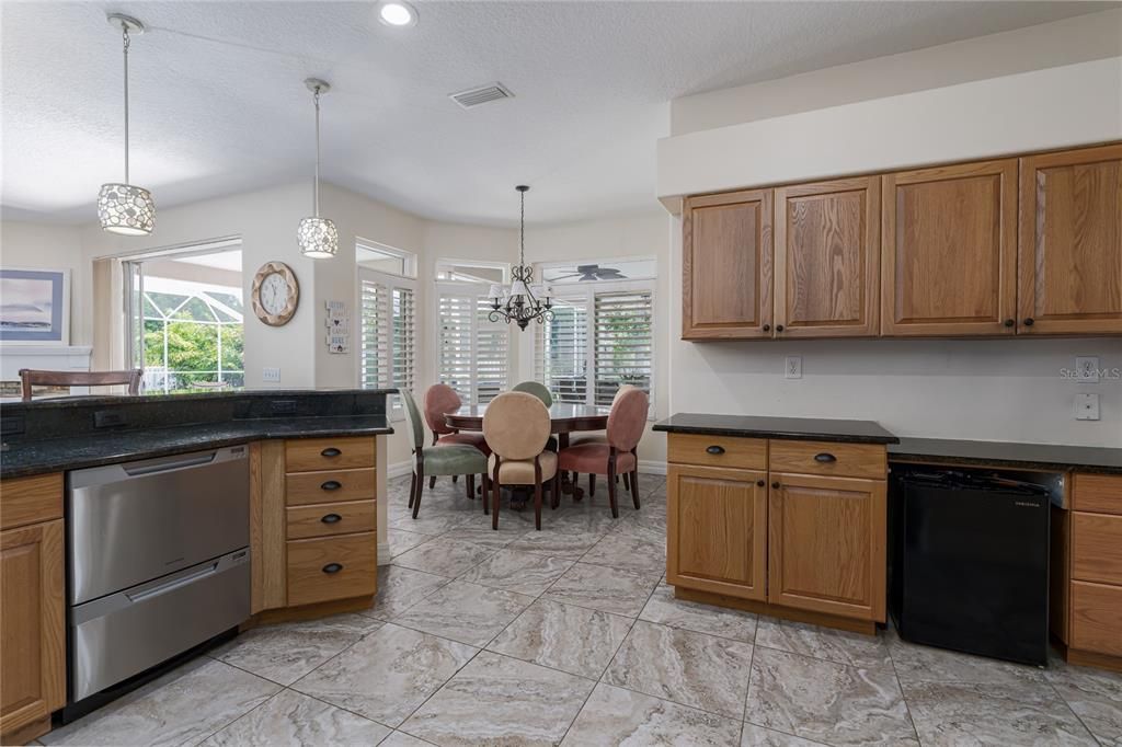 3014 River Woods Dr. Parrish, FL 34219  MLS #A4610018Kitchen, dinette and family rooms open to caged pool area