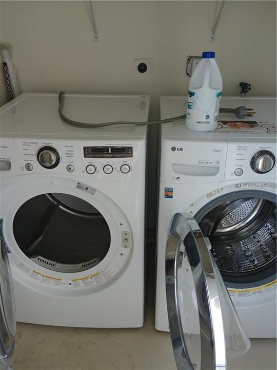 Front load washer and dryer in room off the balcony.