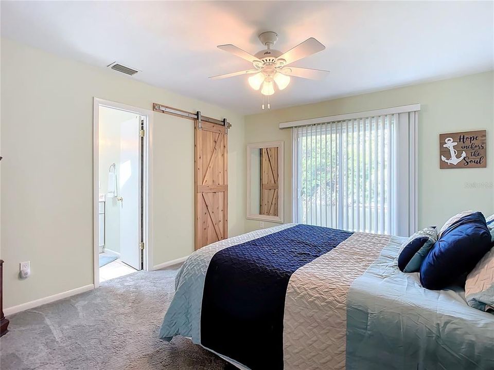 Primary bedroom with ensuite bathroom- Walk in closet with barn style door