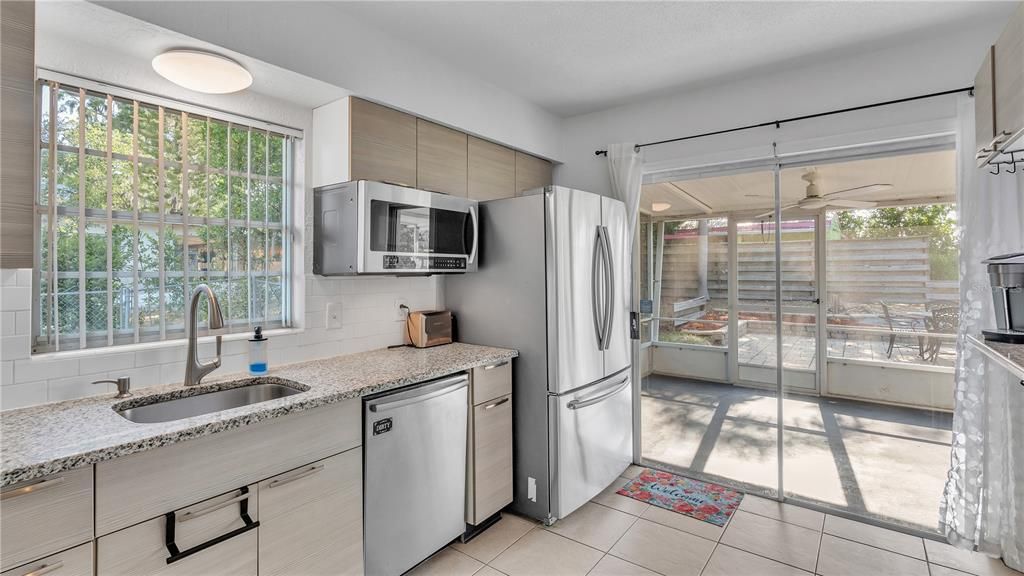 Kitchen Opening to Porch and Pavered Patio