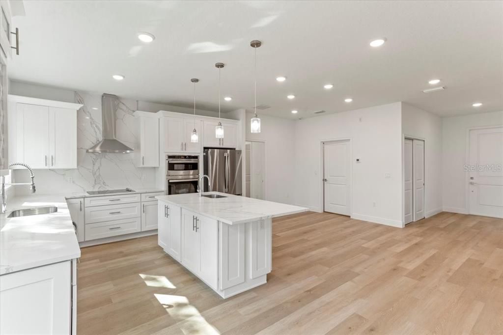 Kitchen Includes Electric Cooktop, Exhaust Hood, Built In Microwave-Oven Combo and Large Fridge