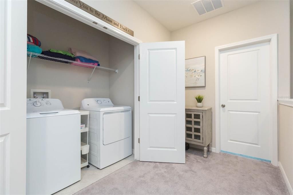 Inside laundry with extra storage is upstairs