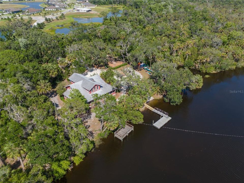 aerial view of amenities area  river house and boat ramp/dock