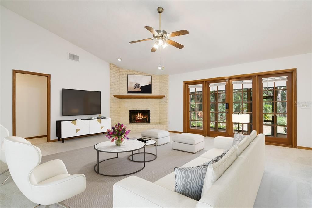 Follow the natural flow into a generous family room featuring a floor to ceiling BRICK FIREPLACE and French door access to a SCREENED LANAI. Virtually Staged.