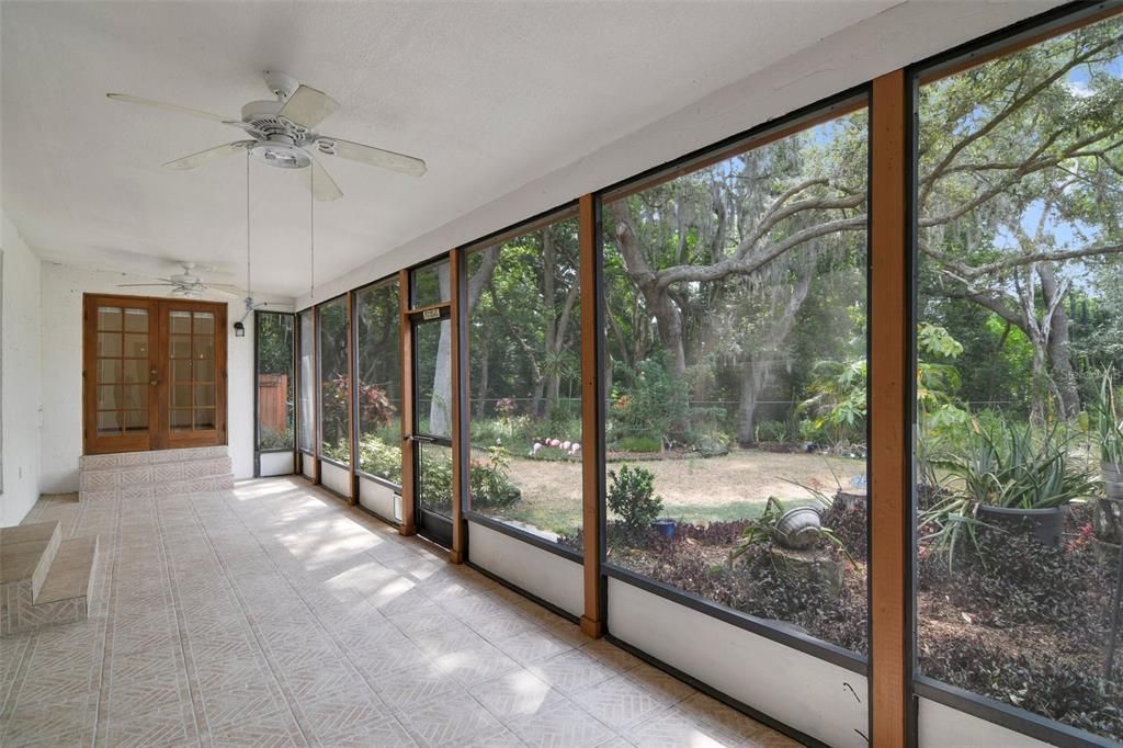 Before exploring the .60 ACRE LOT you have your choice of a SCREENED FRONT PORCH or the screened lanai at the back of the home to enjoy the view the native landscaping provides, creating a tranquil setting while still being close to every convenience.