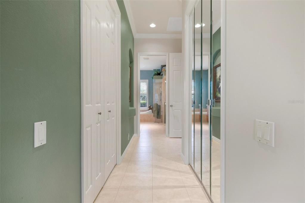Hallway to en-suite primary bathroom has two walk-in closets