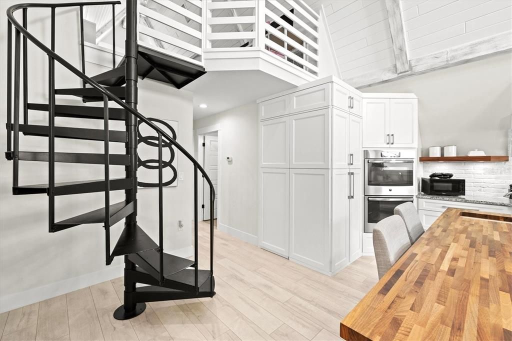 Spiral staircase leads to kids play room.