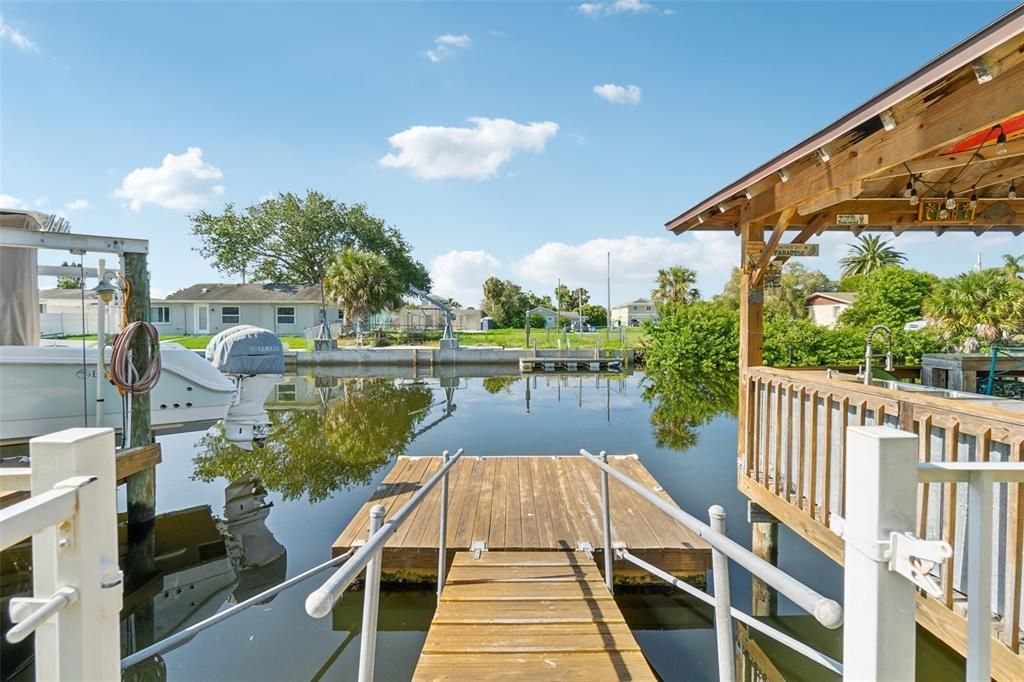 Gate opened up to floating dock with Gazebo on right and boat lift to the left