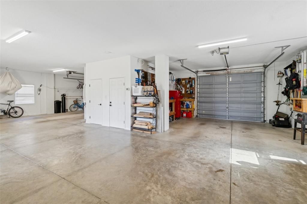 Garage has large storage area under staircase