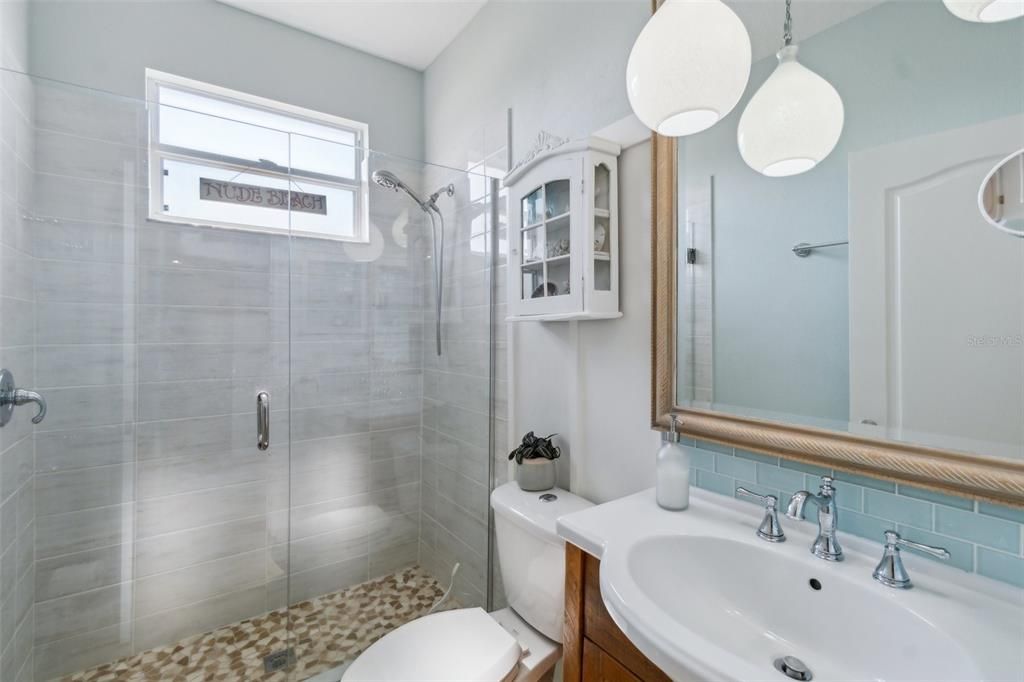 Main floor renovated bathroom located between second and third bedroom