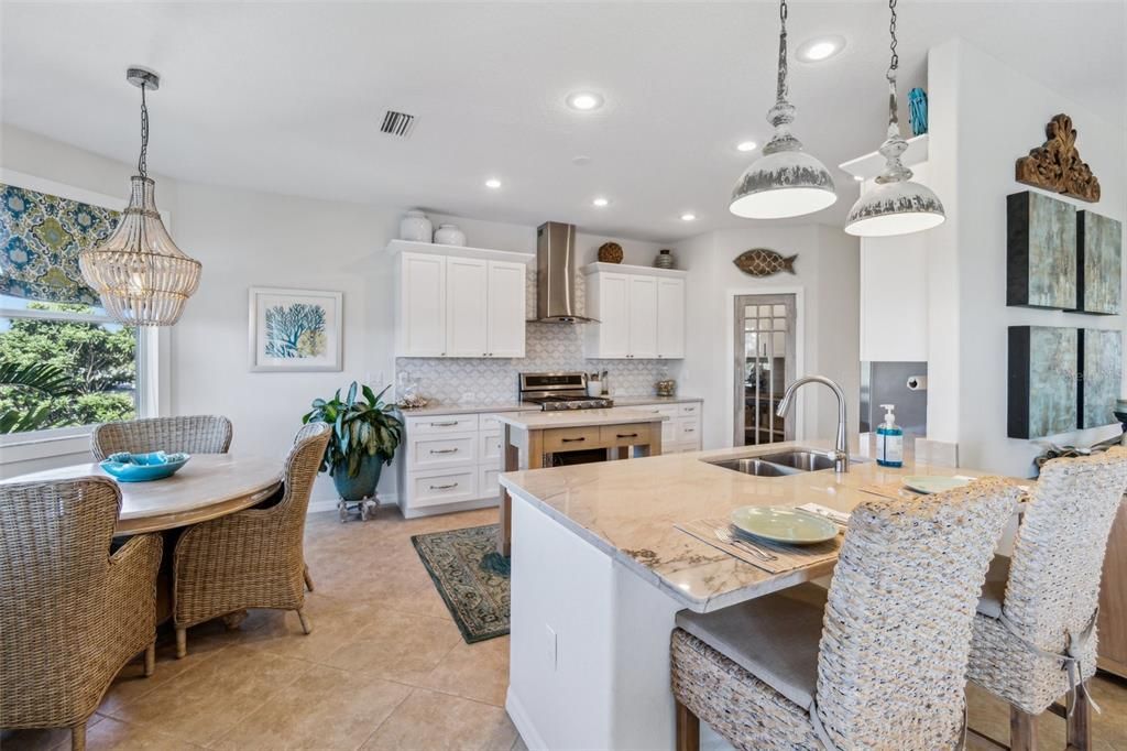 Wide open kitchen view with breakfast bar and kitchen nook