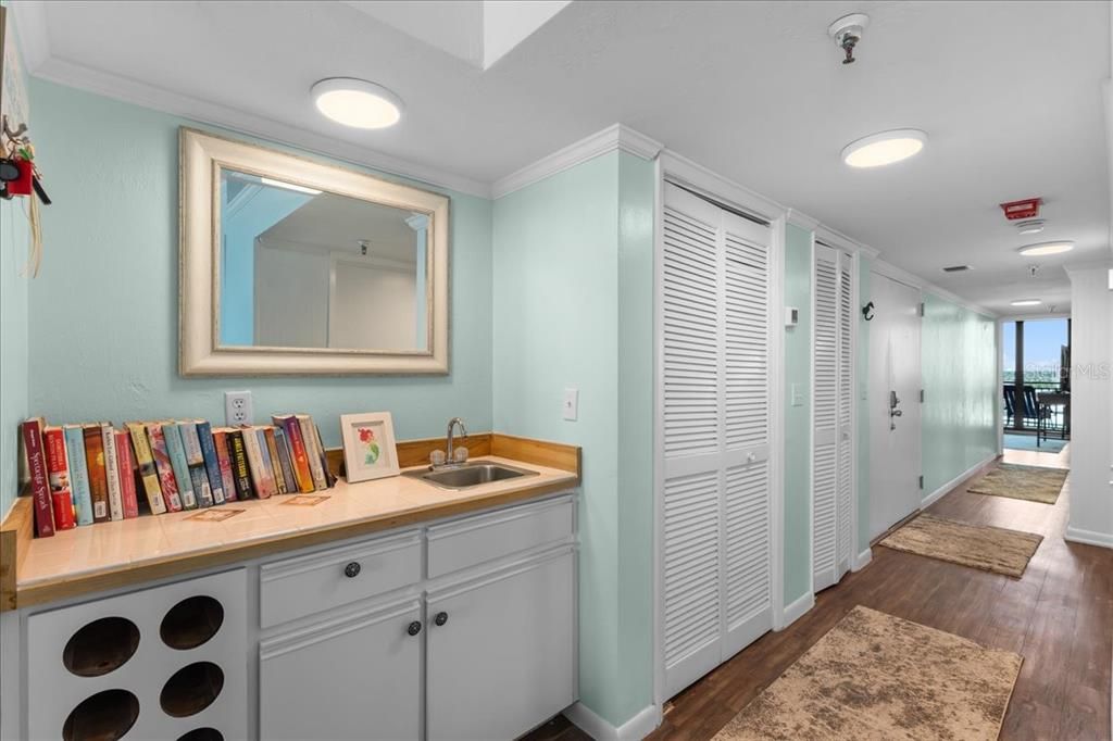 Wet bar, storage closets and hallway to bedrooms and north balcony