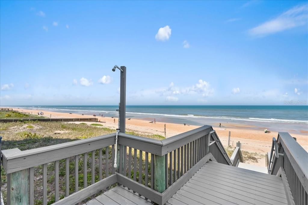 Outdoor shower at beach walkover to sand and surf