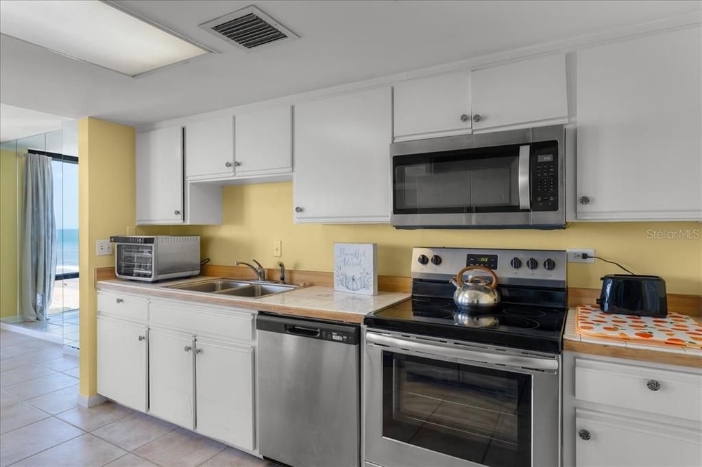 Easy access kitchen with newer stainless steel appliances