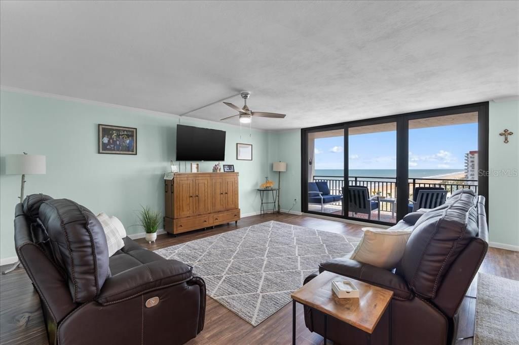 Spacious living room overlooking large balcony and ocean