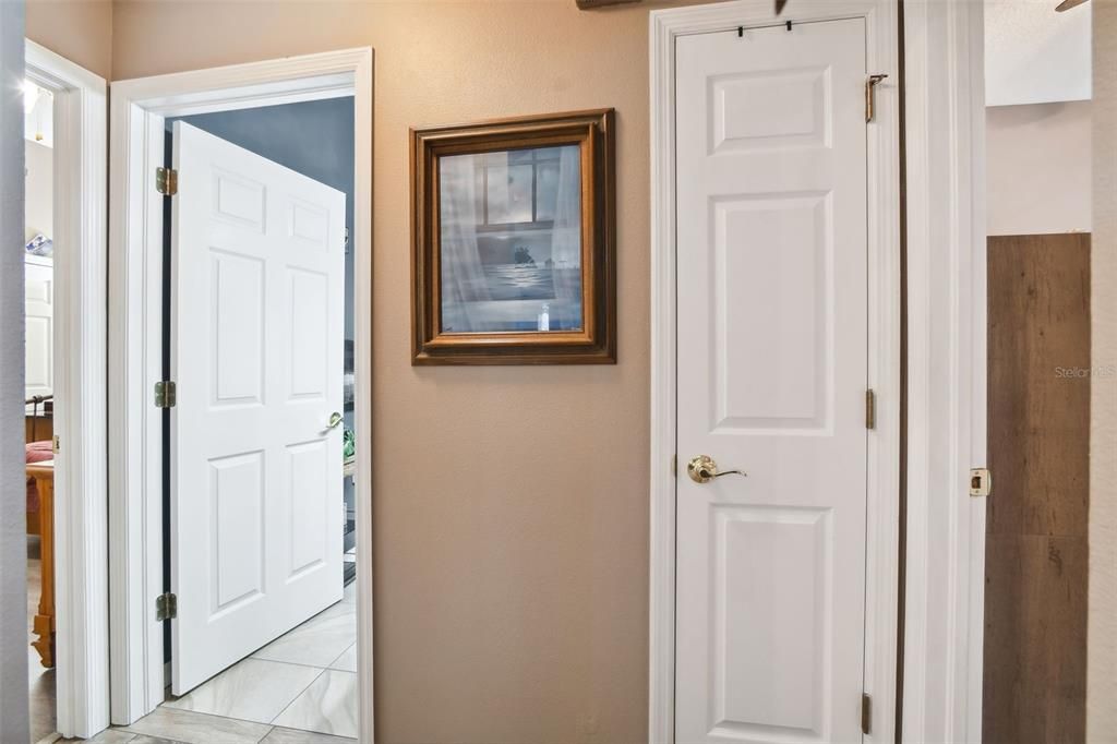 Hallway doorways leading to the other two bedrooms and hallway bathroom.