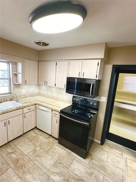 Kitchen with tile top counters and backsplash
