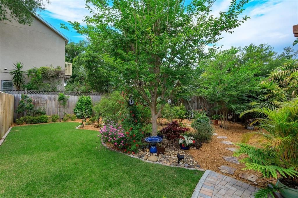 The yard is landscaped with beautiful trees and shrubs that will help you unwind and escape!  Meander to the corner and there is additional secured storage.