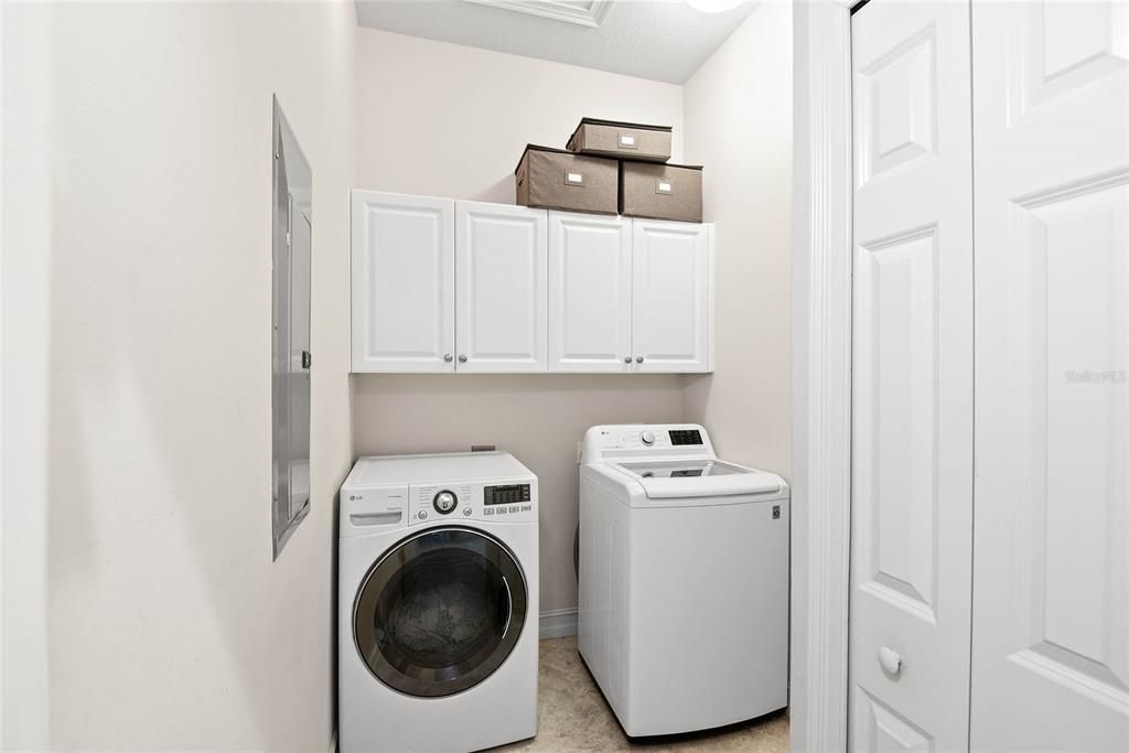 Downstairs Laundry Room with cabinetry