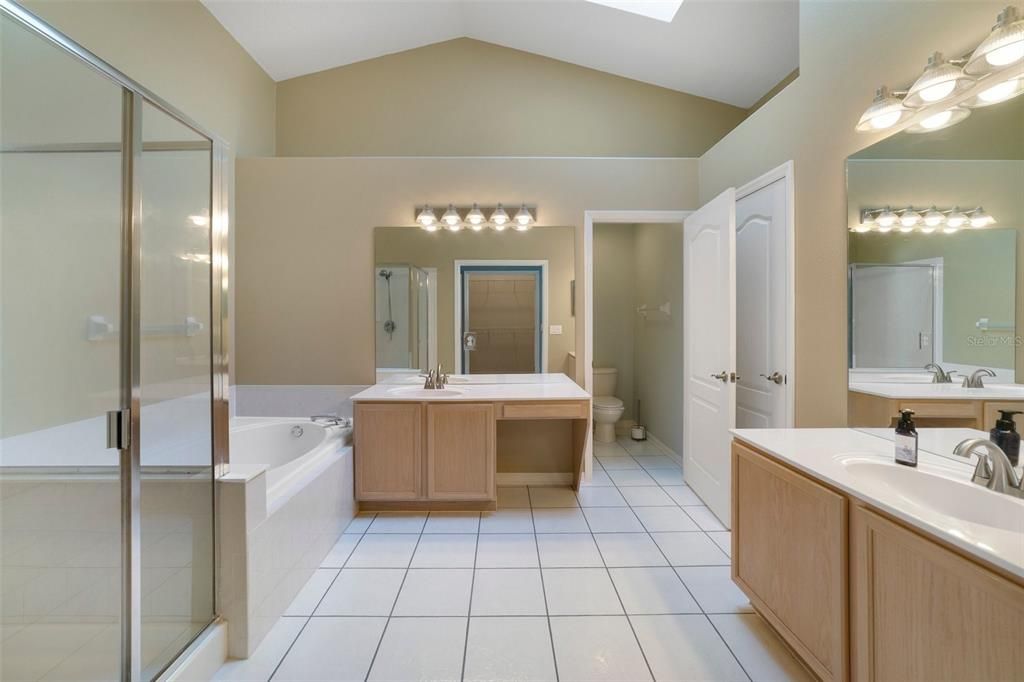 Your en-suite is well appointed with DUAL/SPLIT VANITIES, a soaking tub and large separate shower behind glass doors.