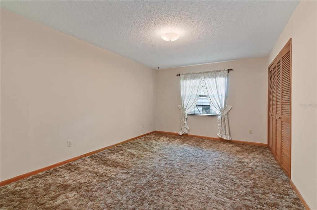 Once you pass the family room and go down the hallway, this is the first guest bedroom.