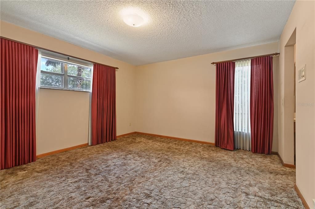 The primary bedroom leading to the ensuite bathroom.