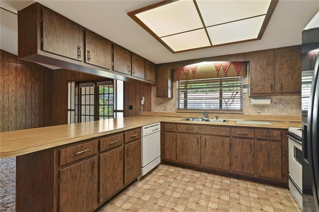 The kitchen has plenty of storage and a breakfast bar.