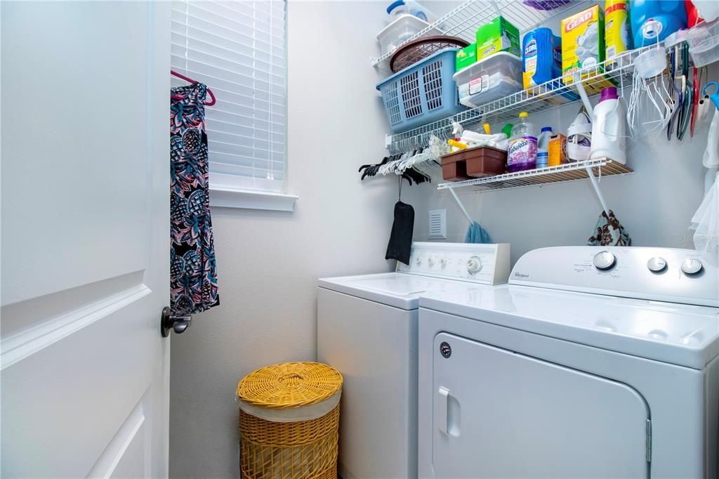 Laundry room on the first floor with storage space