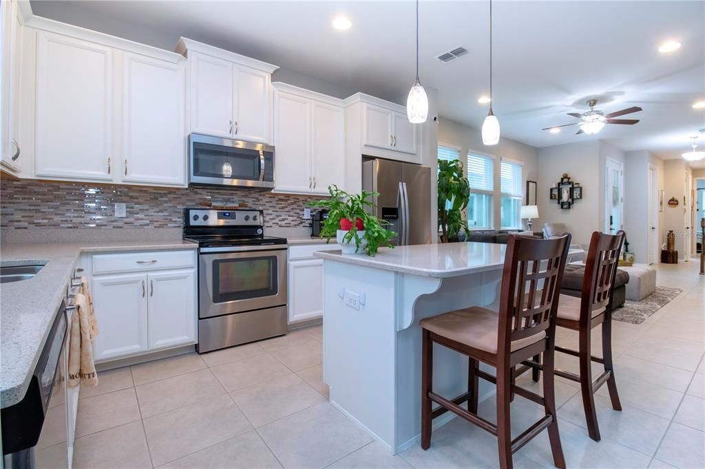 Modern kitchen, updated lighting and fixtures with Quartz counters, plenty of kitchen counters makes food prep easy.