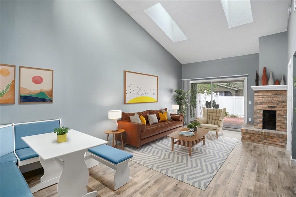 VIRTUALLY STAGED - Light and bright great room with skylights and dining area