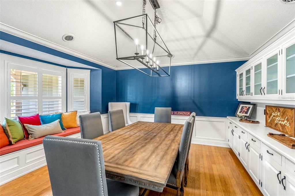 An adorable window seat and custom wood blinds finish off this room