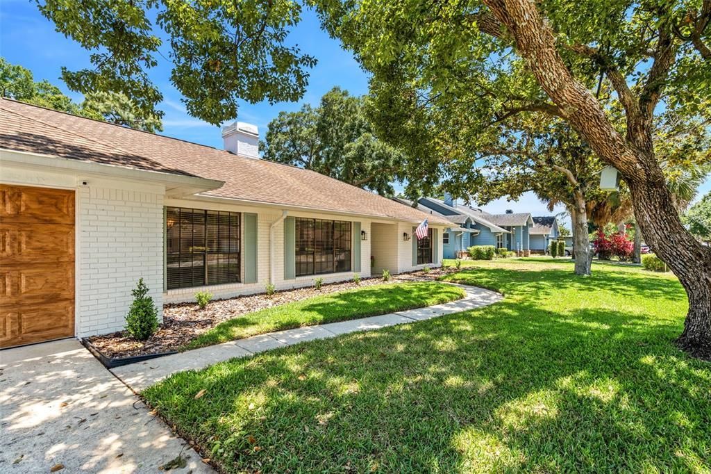 Beautiful mature landscaping welcomes you into this home.