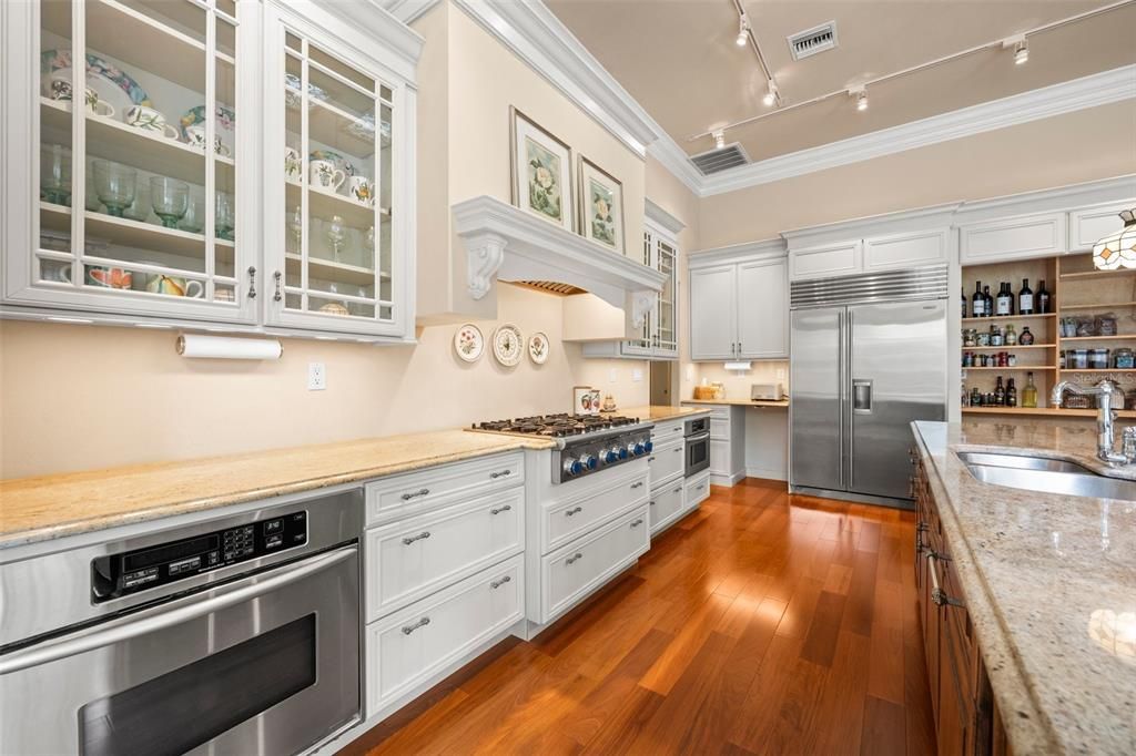 Renovated kitchen showcases a 6-burner gas cooktop, drawer microwave, and sub-zero refrigerator