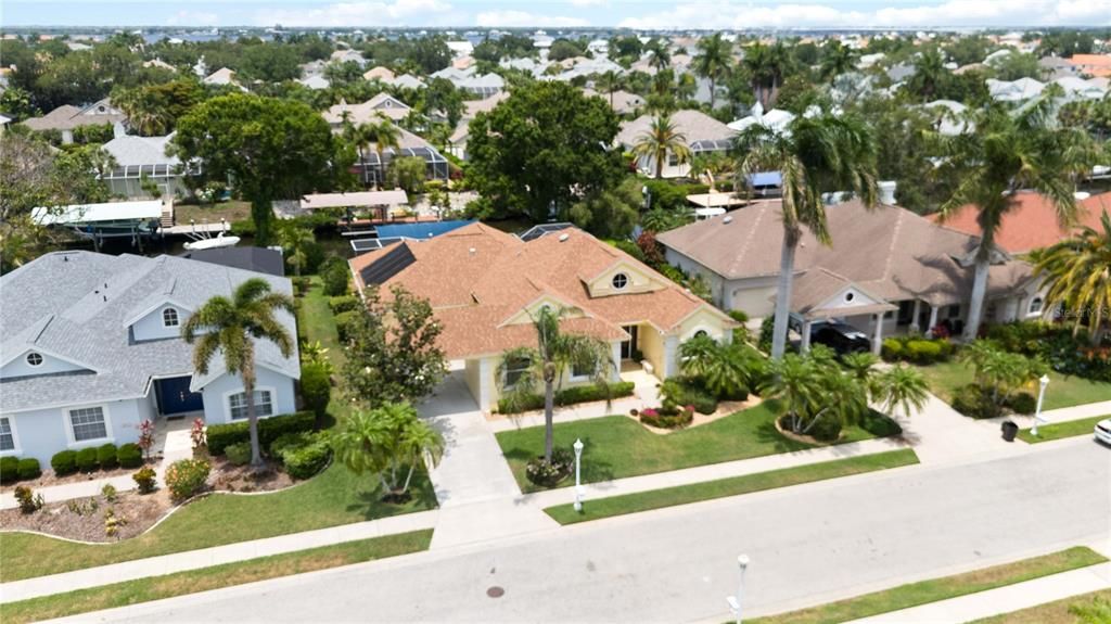 Surrounded by tropical Florida Landscaping with beautiful palms exemplifying luxury coastal living