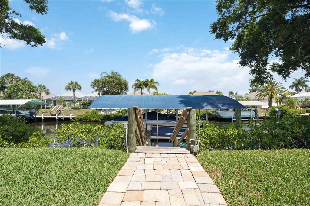 Brick paved walkway leading to 50' private boat dock with electric, water and outdoor lighting and 15,000 LBS boat lift.