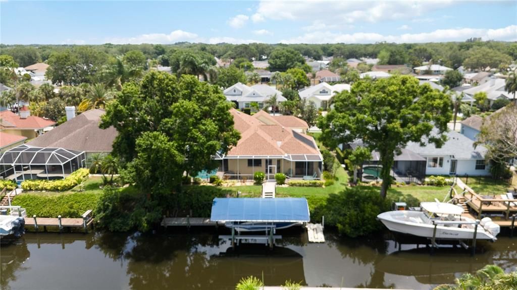 Located in the exclusive boating community of The Inlets at Riverdale overlooking the saltwater canal, with private access to covered 50' dock and 15,000 lbs. Alumavator lift.