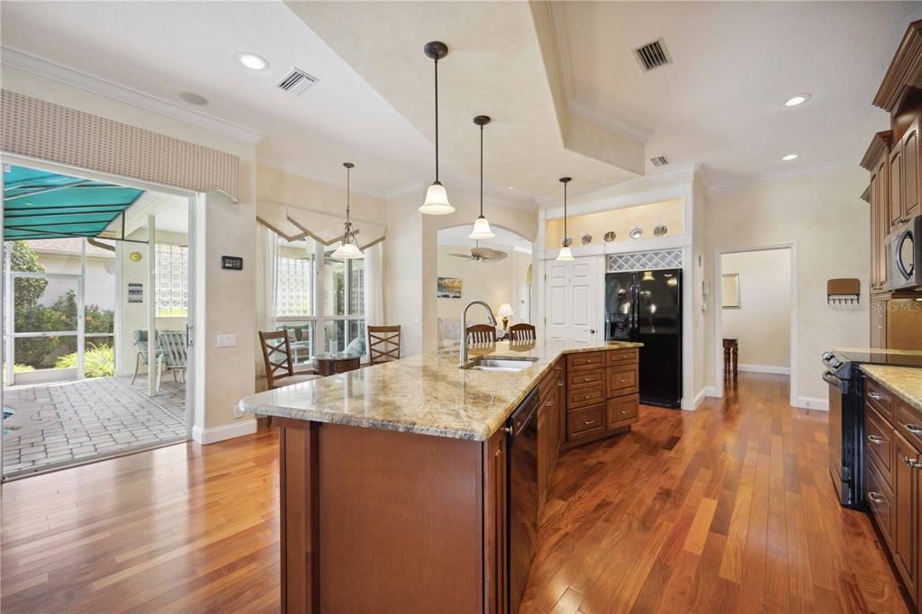 Another direct access to pool area from kitchen which is filled with plenty of storage within 42' custom wood cabinets with soft close doors.