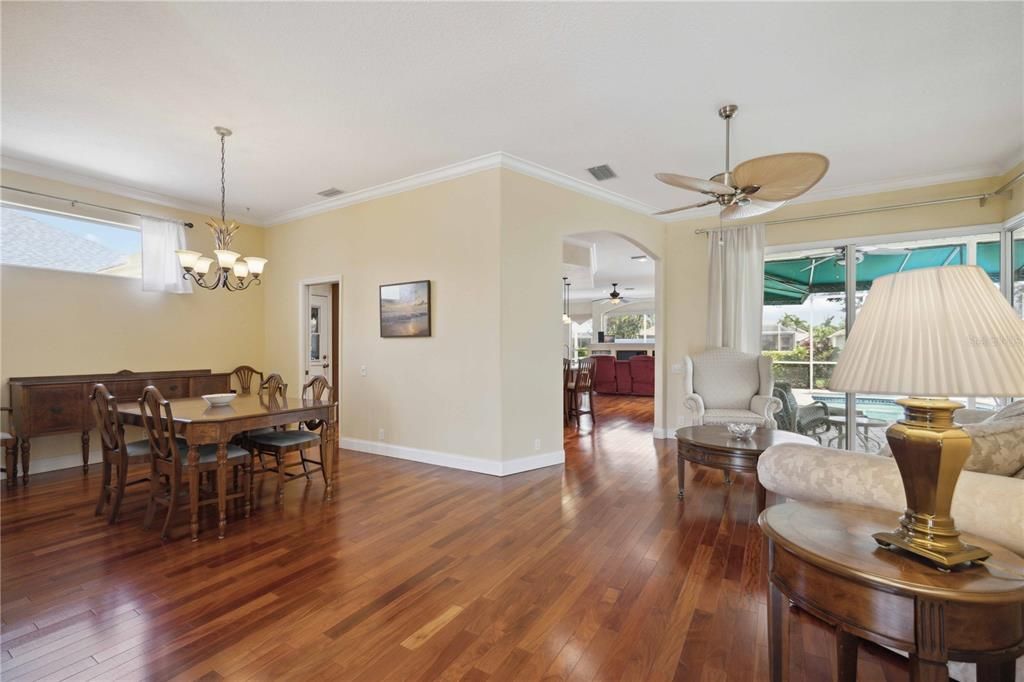 Open floor plan, seamlessly flows into the main area of the house connecting dining room, living area and entrance to kitchen with Brazilian Mahogany hardwood floors. Sunlight fills this space always giving that coastal feeling.