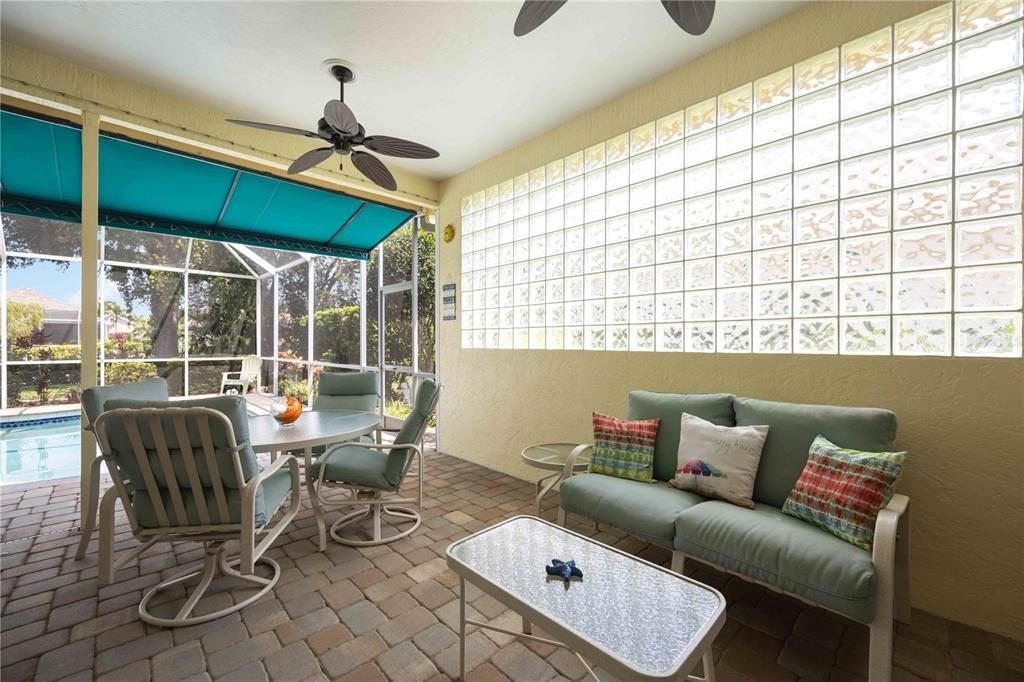 Covered lanai with double fans to stay cool while overlooking pool and enjoying company.