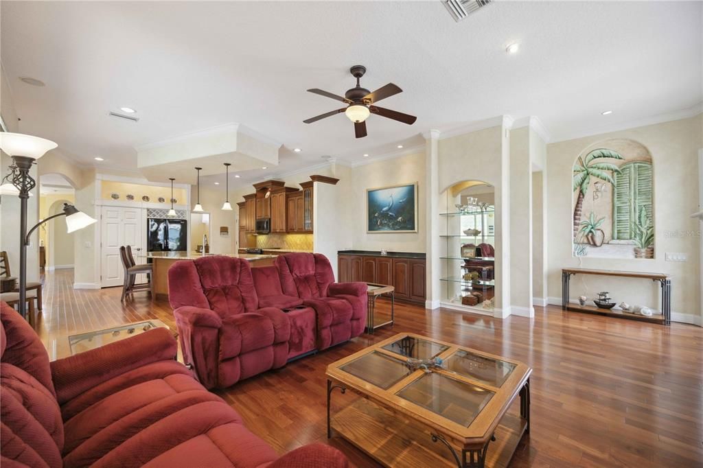 Spacious, beautifully lit family room with electric fireplace for those Florida "winter" nights and a dry bar to hold all the necessities for hosting.