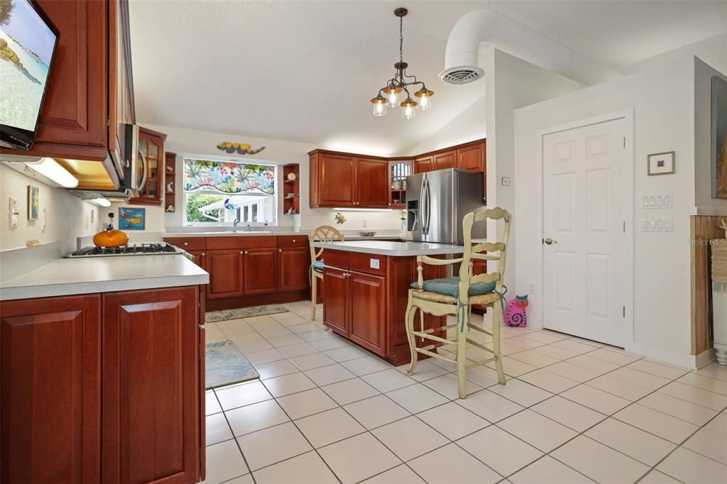 Kitchen with lots of cabinet and counter space and a full-sized pantry. Bright and inviting with gas cooking