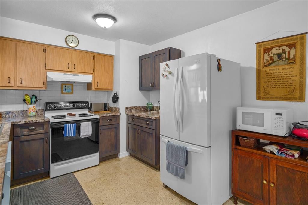The u-shaped kitchen provides ample workspace and storage and features newer appliances.