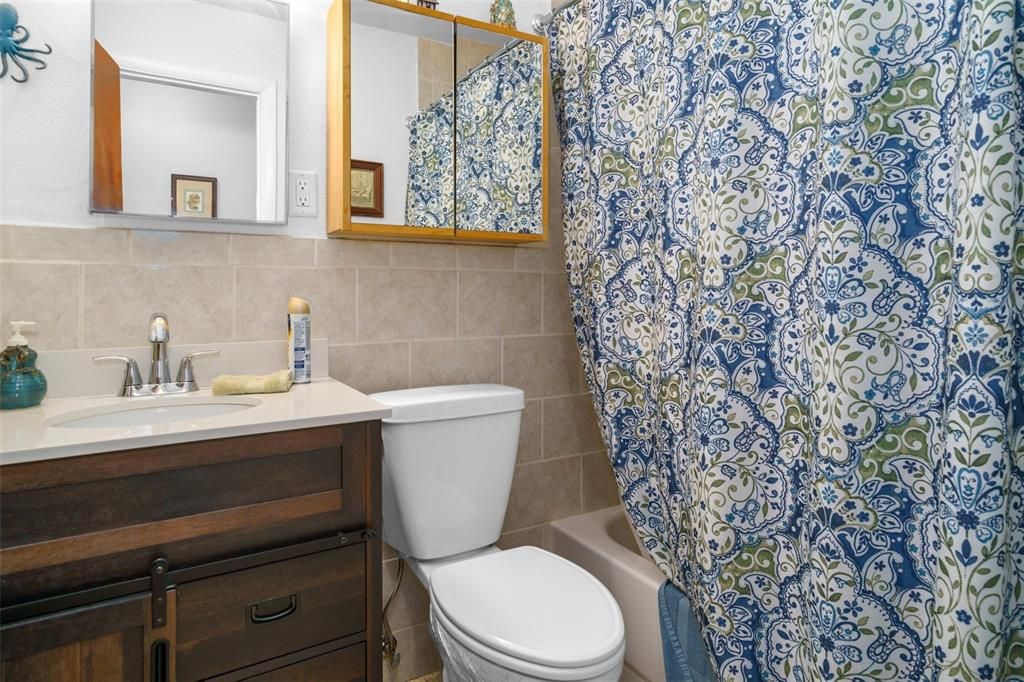 The Hall Guest Bath has also been remodeled and has a linen closet behind the bathroom door.