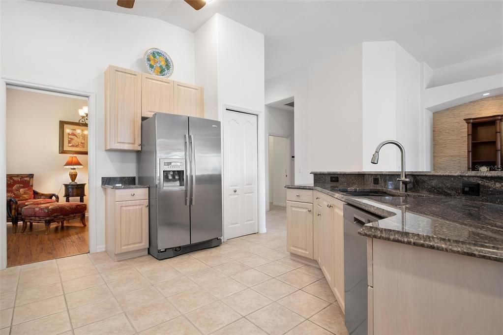 Kitchen with granite counters, peek-a-boo look into dining room/den