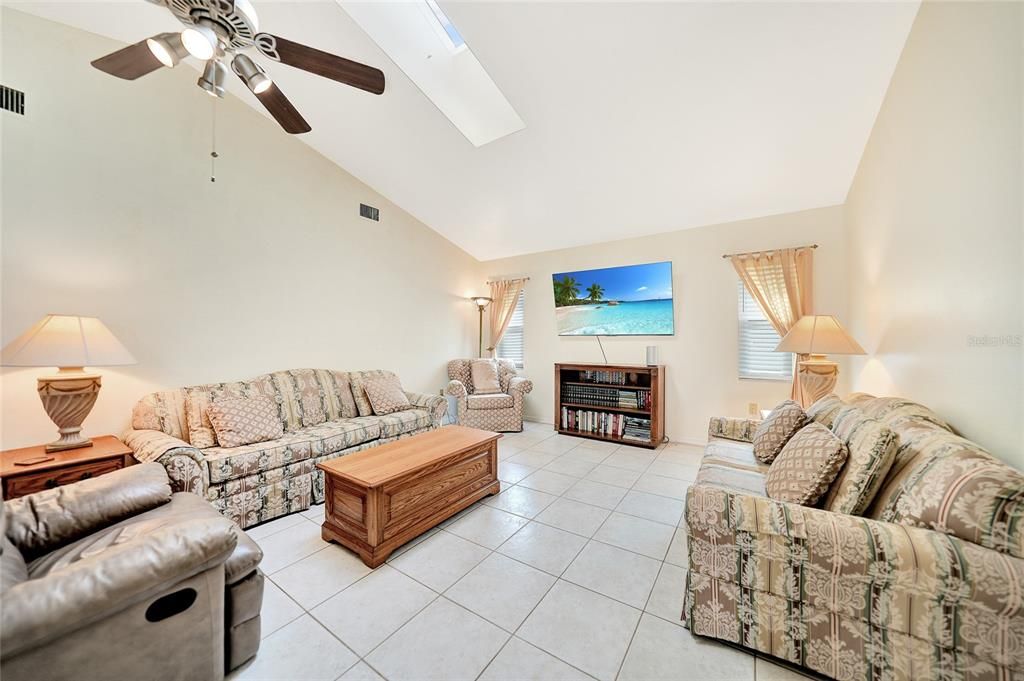 Family room with high ceilings and another skylight for added natural light